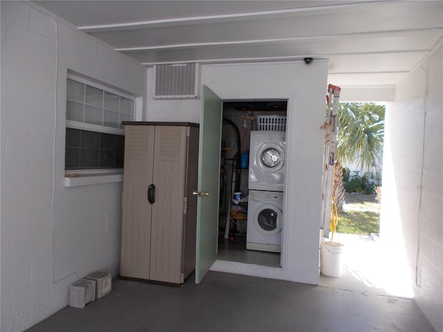 garage with stacked washing maching and dryer