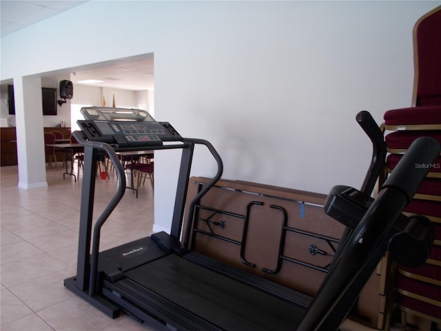 workout room featuring light tile patterned floors