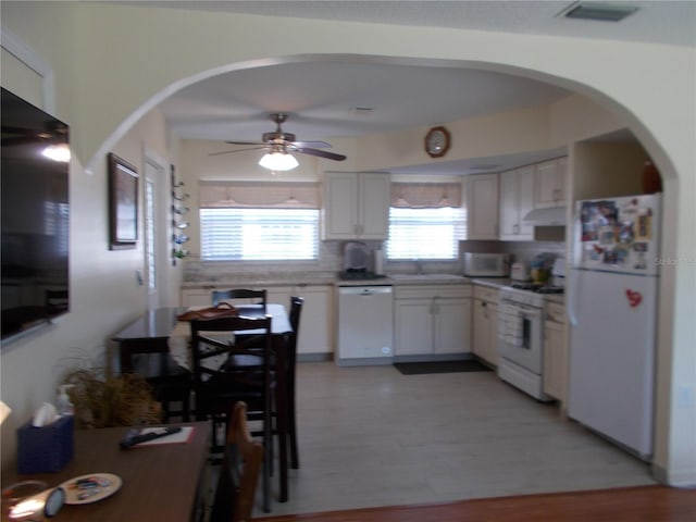 kitchen with sink, white appliances, ceiling fan, white cabinets, and light wood-type flooring