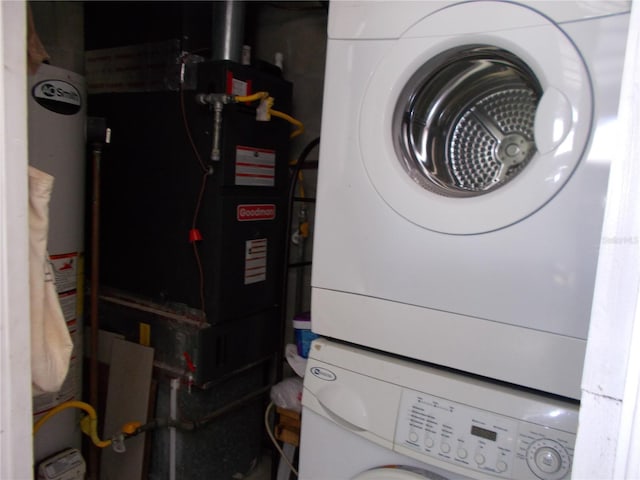 utility room with stacked washer / dryer and gas water heater