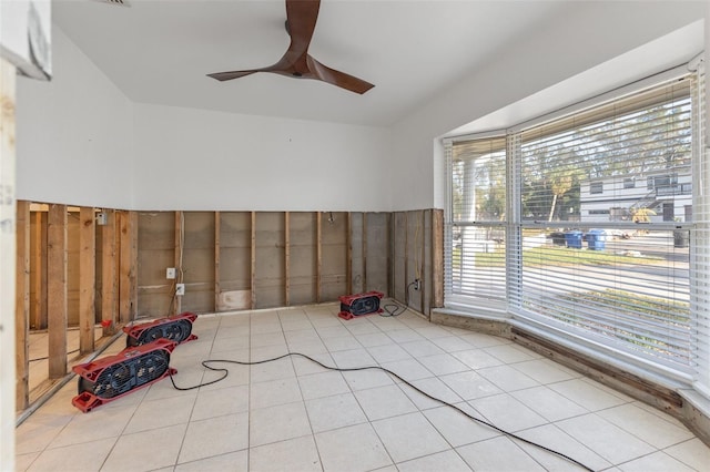 tiled empty room featuring ceiling fan