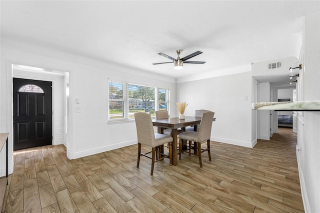 dining room with ceiling fan and light wood-type flooring