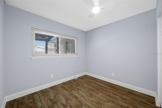 empty room with ceiling fan and dark hardwood / wood-style flooring