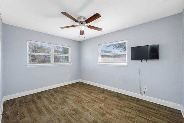 spare room featuring ceiling fan and dark hardwood / wood-style flooring