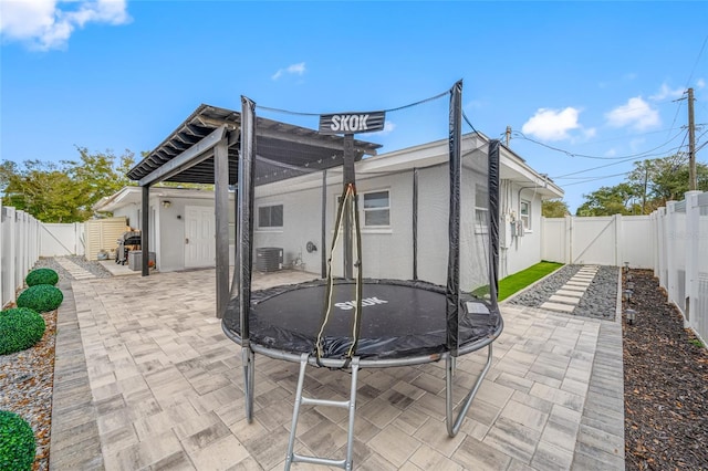 view of patio with a trampoline and central AC