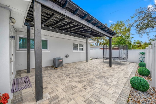 view of patio / terrace with central AC unit and a trampoline