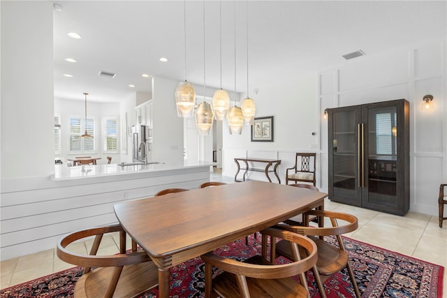 tiled dining area featuring sink