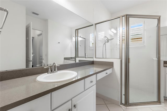 bathroom featuring vanity, tile patterned floors, and a shower with shower door