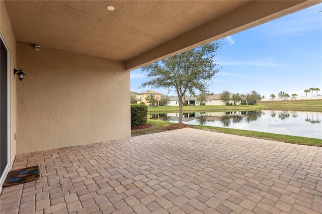 view of patio featuring a water view