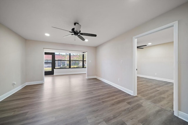 unfurnished room with ceiling fan and dark hardwood / wood-style floors