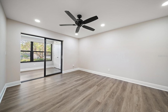 spare room featuring wood-type flooring and ceiling fan