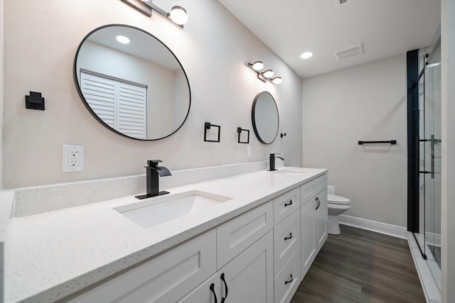 bathroom featuring vanity, hardwood / wood-style flooring, and toilet