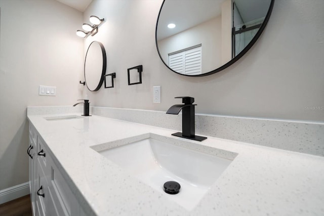 bathroom featuring vanity and hardwood / wood-style flooring