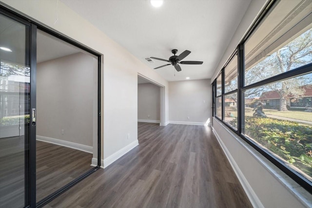 interior space featuring dark wood-type flooring and ceiling fan