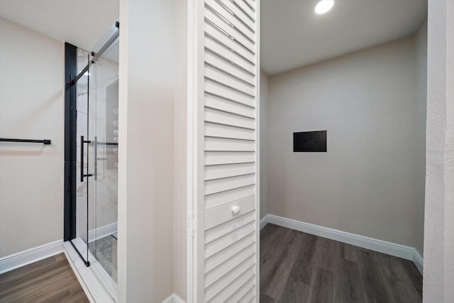 bathroom featuring hardwood / wood-style flooring and a shower with door