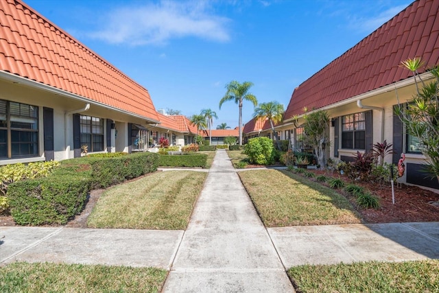 view of home's community with a yard