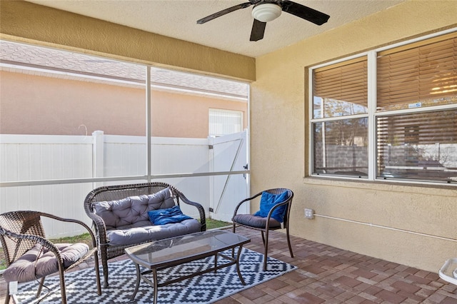 view of patio featuring ceiling fan, an outdoor hangout area, and fence