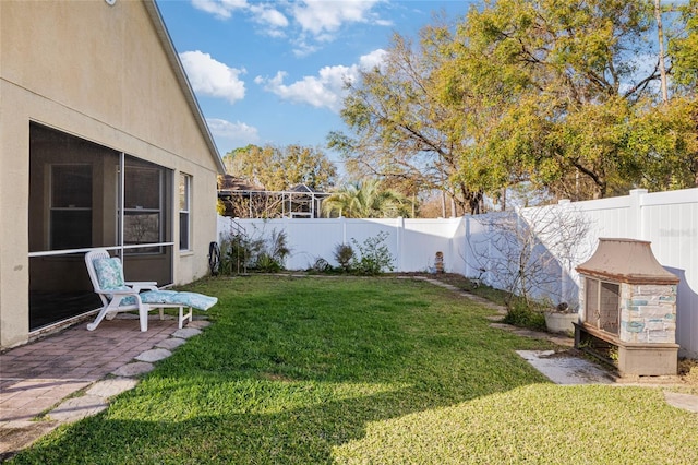 view of yard featuring a patio area and a fenced backyard