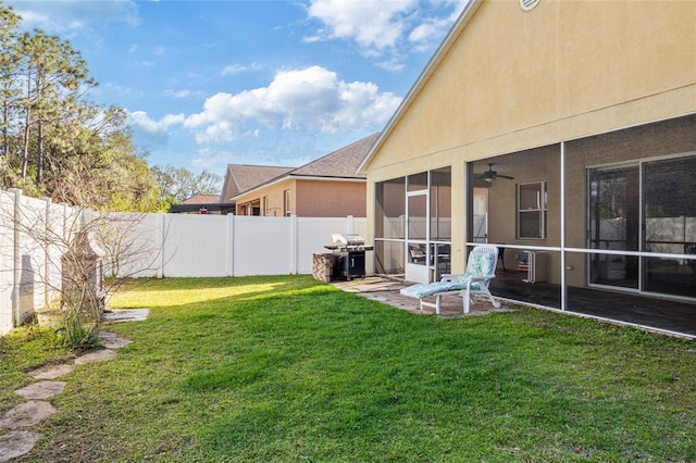 view of yard with a patio area, a fenced backyard, and a sunroom