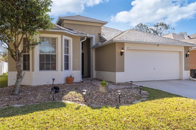 view of front of property with a garage, a shingled roof, concrete driveway, stucco siding, and a front yard