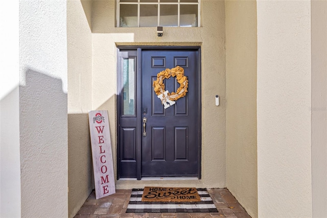 doorway to property with stucco siding