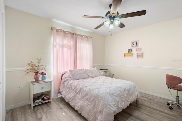 bedroom with light hardwood / wood-style floors and ceiling fan