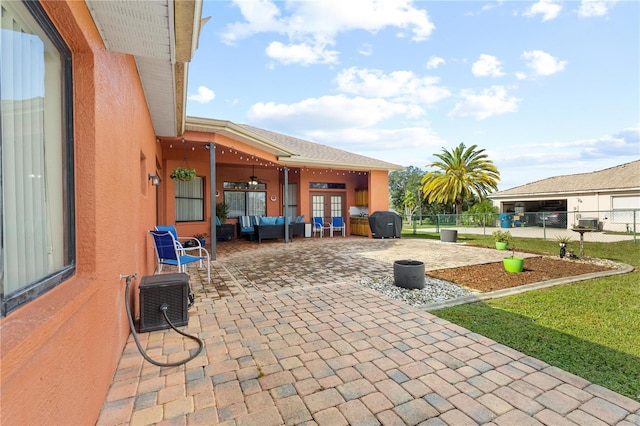 view of patio featuring outdoor lounge area, french doors, and ceiling fan