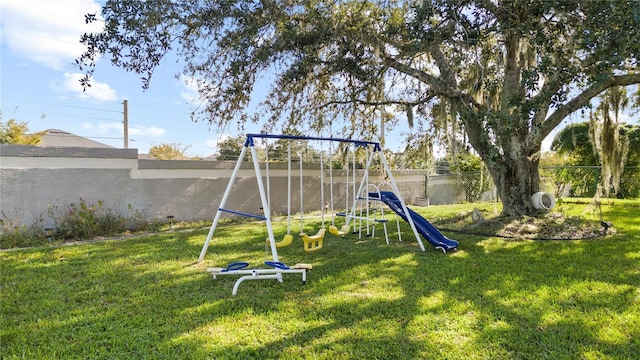 view of jungle gym featuring a lawn