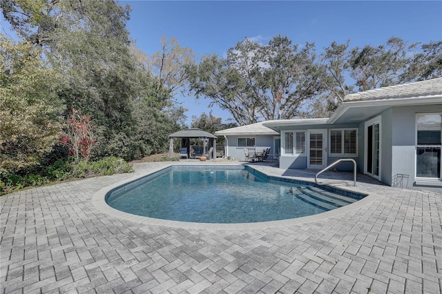 view of swimming pool featuring a gazebo and a patio area