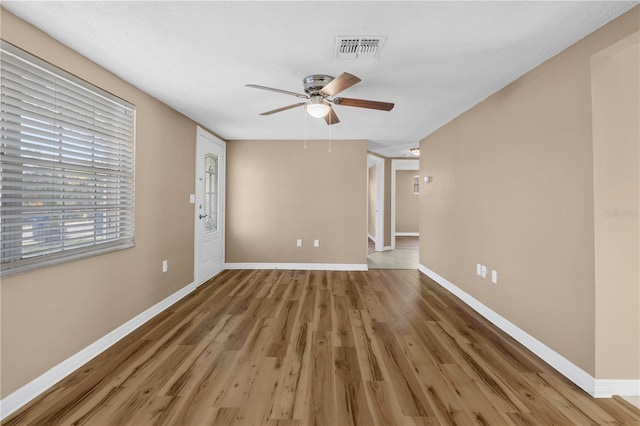 unfurnished room with hardwood / wood-style flooring and ceiling fan