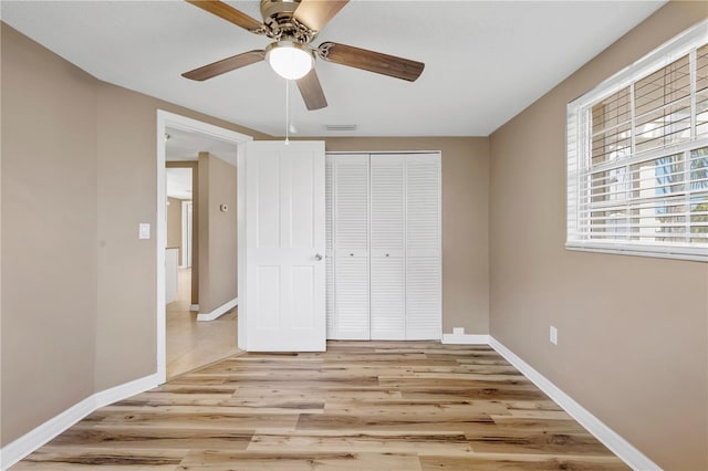 unfurnished bedroom featuring a closet, ceiling fan, and light hardwood / wood-style flooring