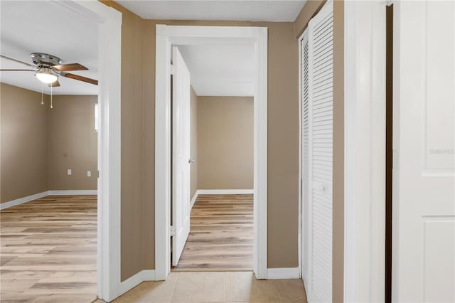 hall featuring light tile patterned floors