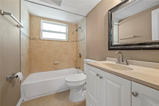 full bathroom featuring tiled shower / bath, tile patterned floors, toilet, and vanity