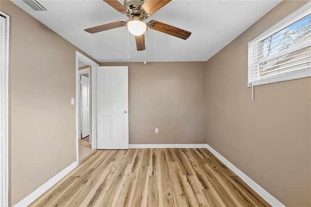 unfurnished bedroom with ceiling fan and light hardwood / wood-style floors