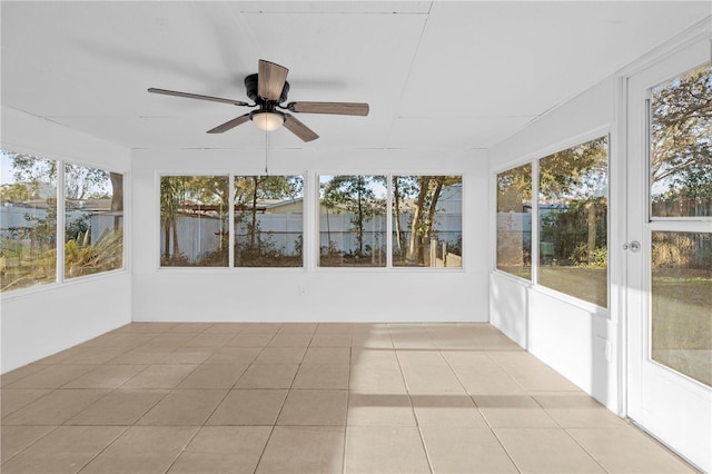 unfurnished sunroom featuring ceiling fan