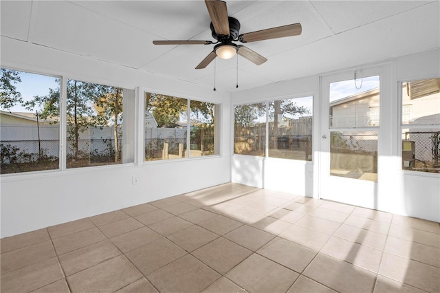 unfurnished sunroom featuring ceiling fan