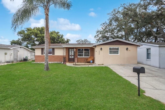 ranch-style home with cooling unit and a front lawn