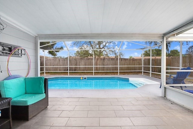 view of swimming pool with a lanai and a patio area