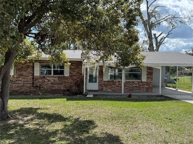 view of front facade with a front yard and a carport