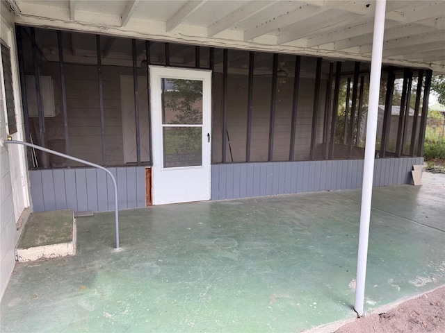 view of patio featuring a sunroom