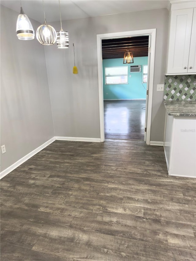 unfurnished dining area with dark hardwood / wood-style flooring