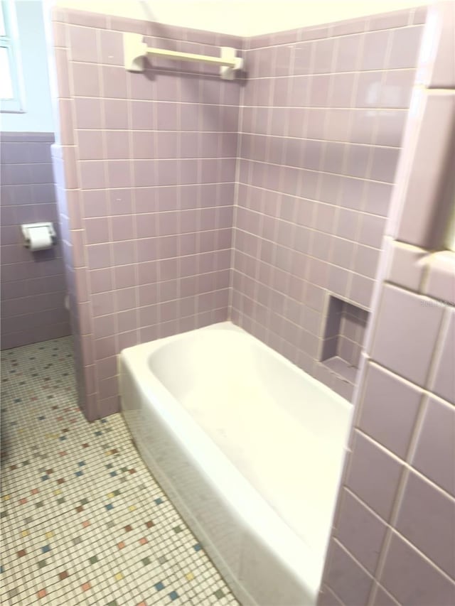 bathroom with plus walk in shower, tile walls, and tile patterned floors