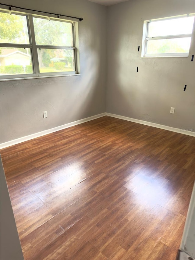 spare room featuring dark hardwood / wood-style floors