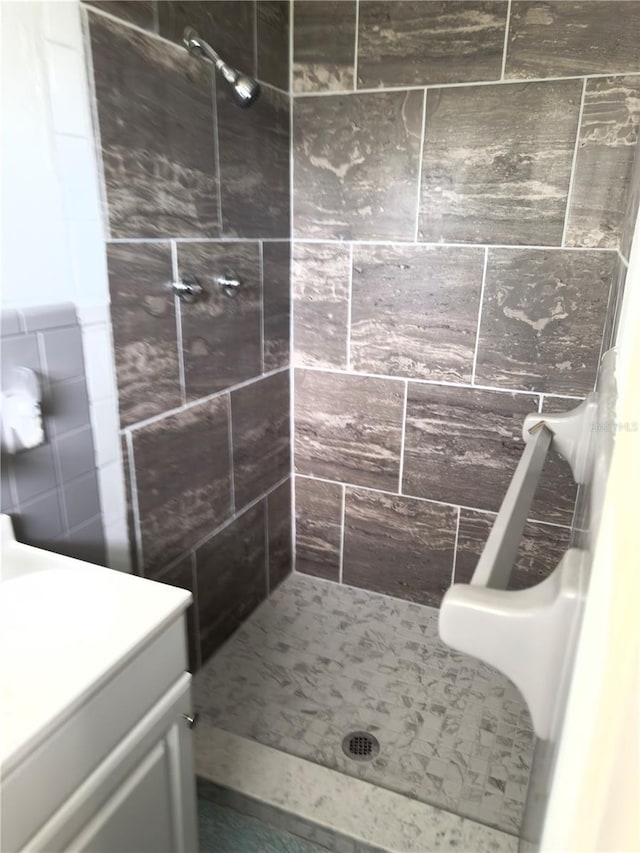 bathroom featuring vanity and tiled shower