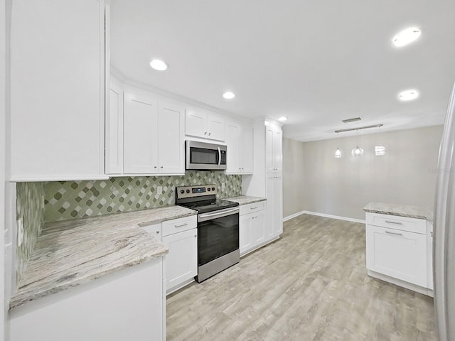 kitchen with tasteful backsplash, decorative light fixtures, light wood-type flooring, appliances with stainless steel finishes, and white cabinetry