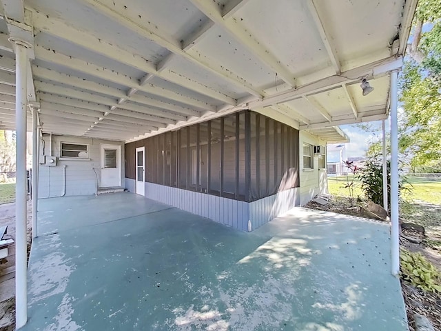 view of patio / terrace with an attached carport and a sunroom