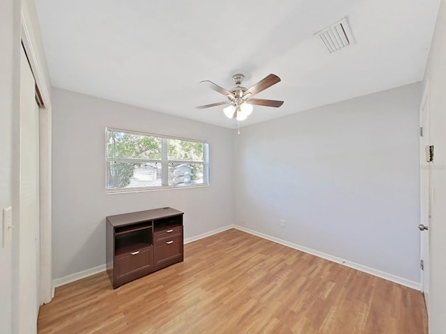 unfurnished bedroom with a closet, visible vents, light wood-type flooring, and baseboards