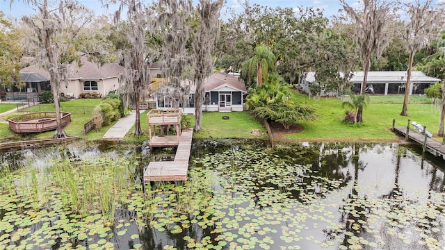 dock area with a water view and a yard