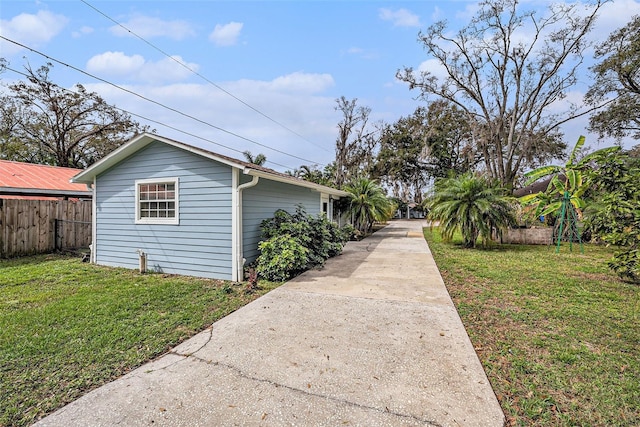 view of side of property with a yard and fence