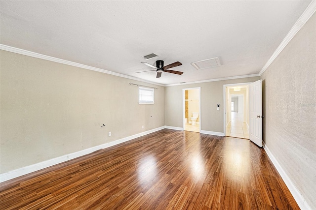 unfurnished room featuring baseboards, visible vents, ceiling fan, ornamental molding, and wood finished floors